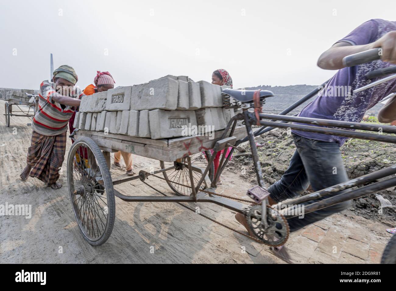 After the raw clay bricks are dried, they are stacked up inside a fixed