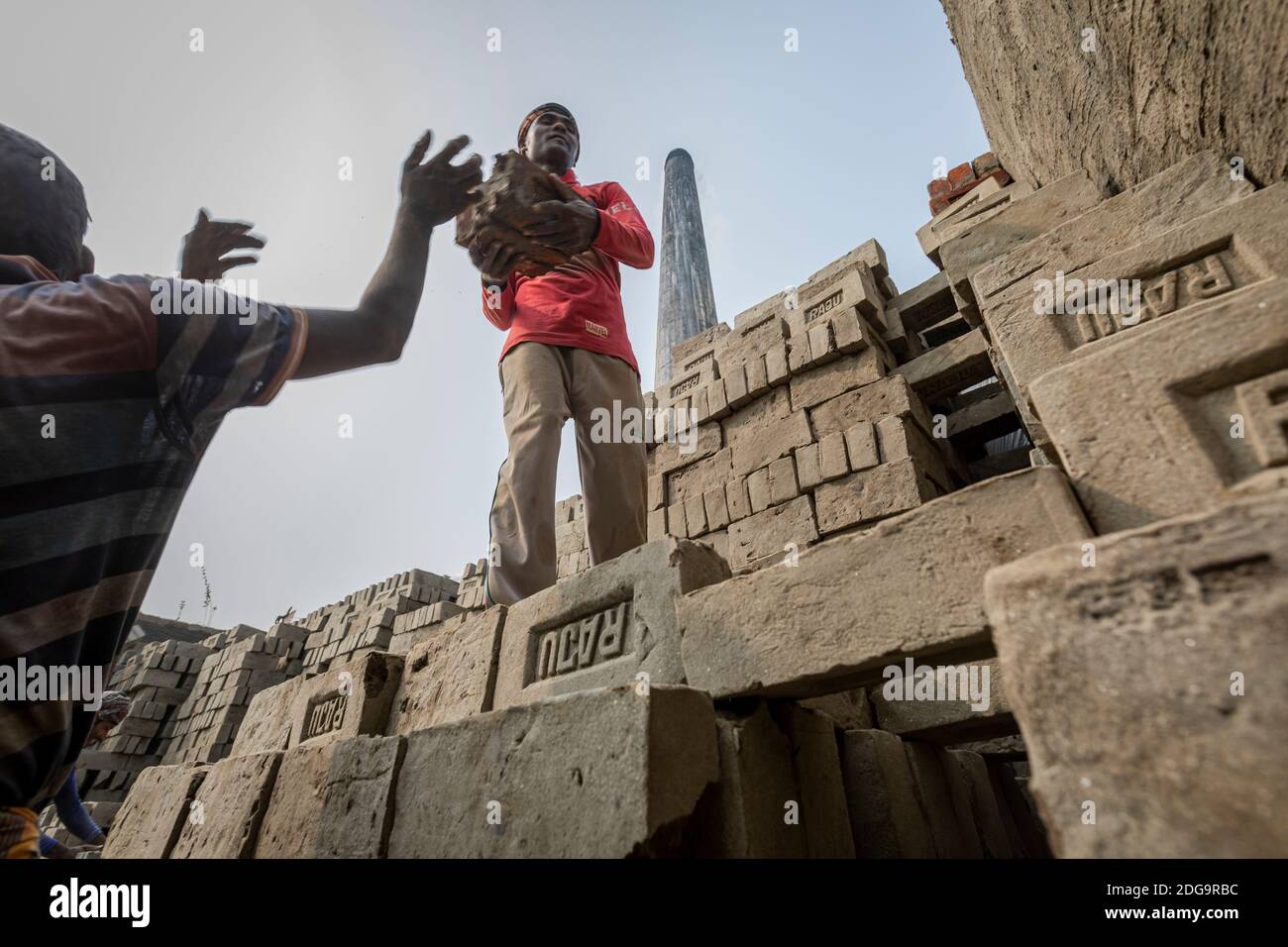 After the raw clay bricks are dried, they are stacked up inside a fixed