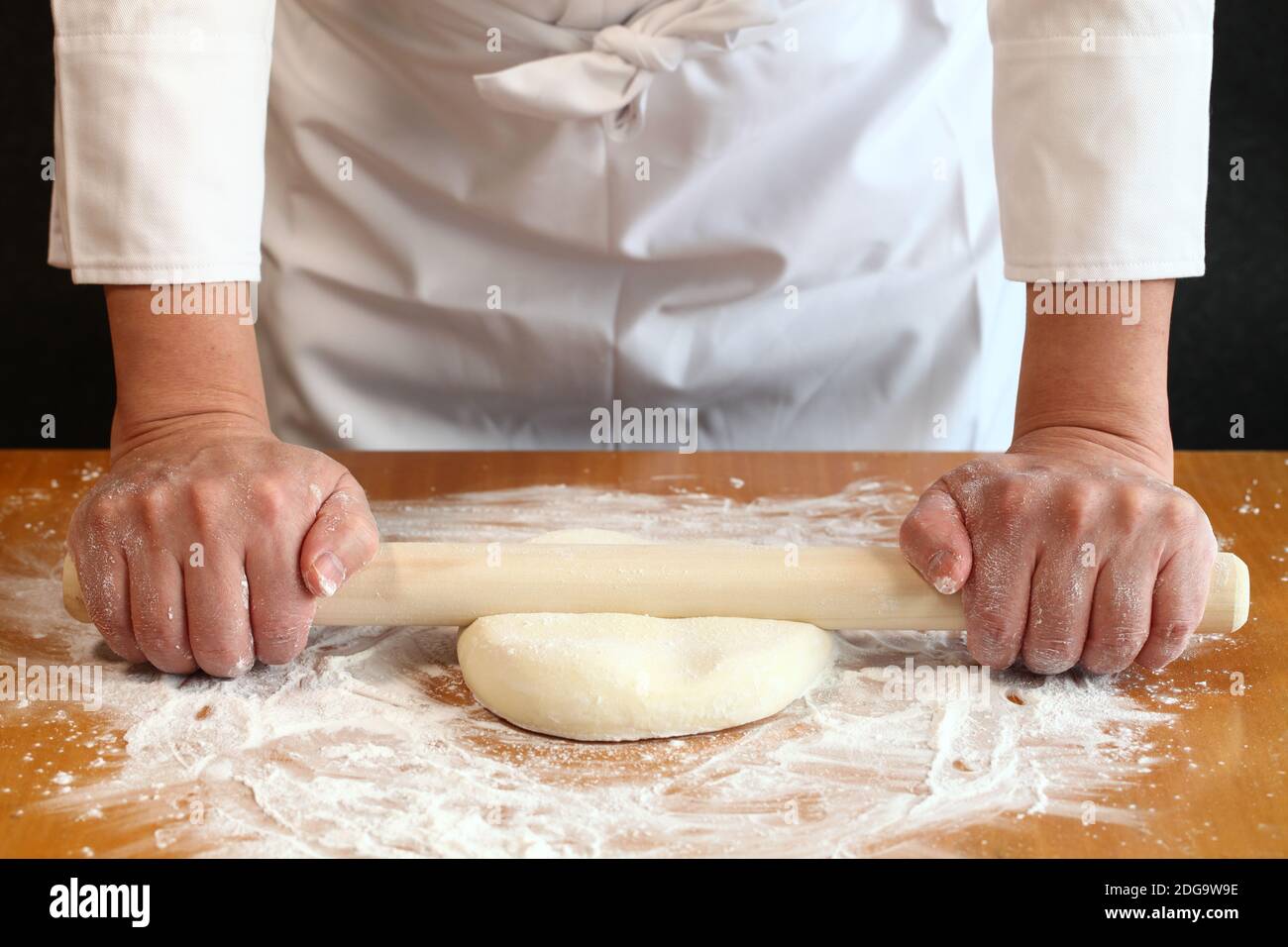 how to make japanese udon noodles; use a rolling pin to press a kneaded
