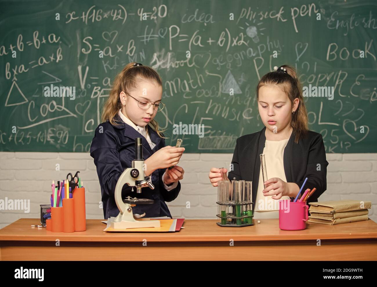 Scientific researches. Little scientist work with microscope. Little girls in school lab. Formal school education. Biology school lesson. Chemistry research. science experiments in laboratory. Stock Photo