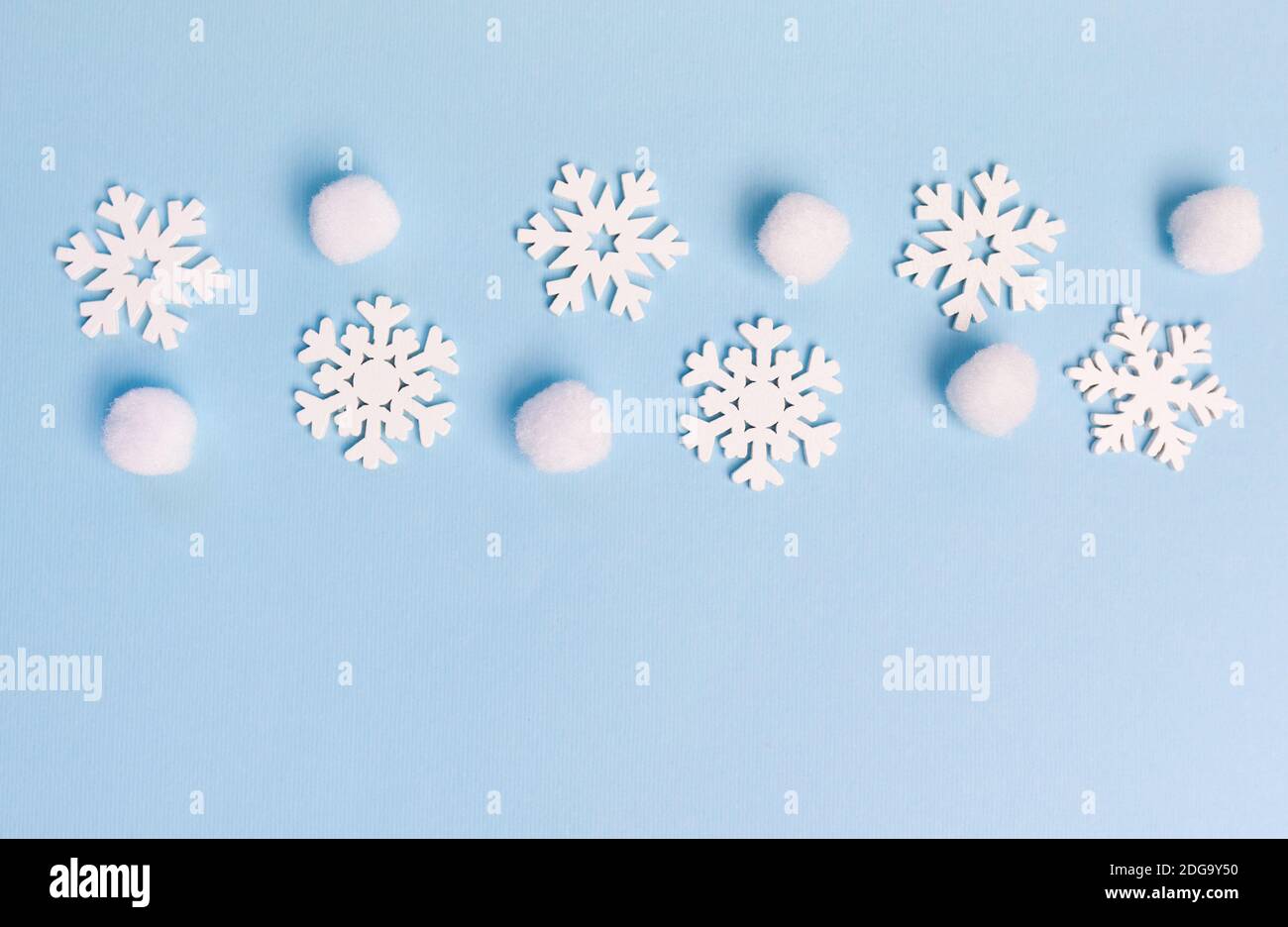 Christmas greeting card with line of snowflakes on blue backgroun. Xmas holiday postcard with place for your text. Happy New Year Stock Photo