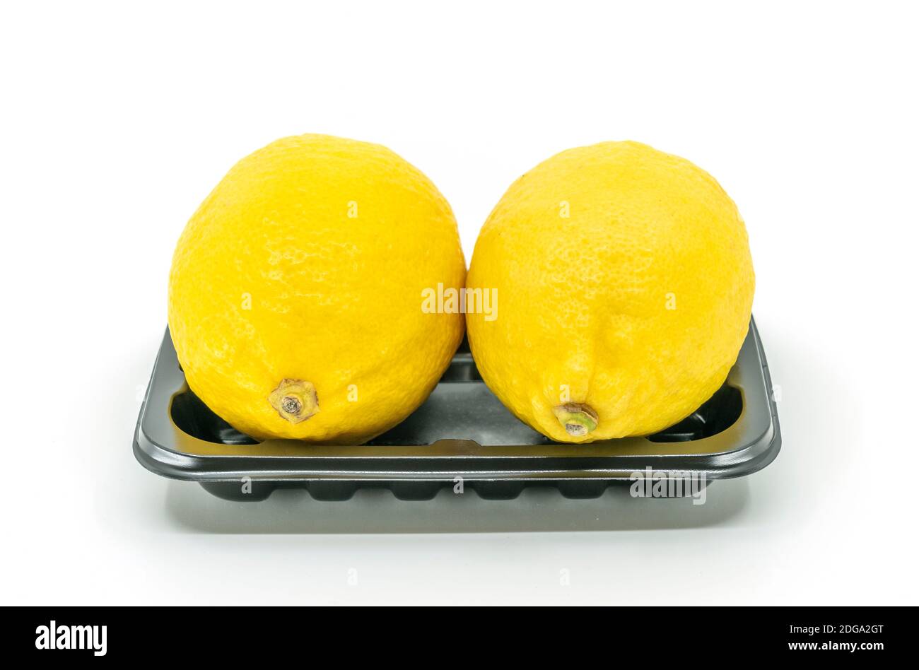 Front view fresh organic yellow lime in black tray for sell in market ...