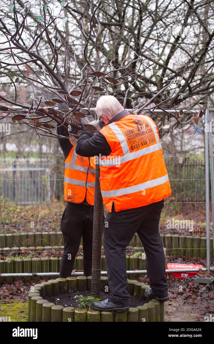 Glasgow, Scotland, UK. 8 December 2020. Pictured: (left) Reece Dixon - Health & Safety Lead, and (right) Grant Fitzimmons) CEO of Grant Fitzsimmons & Son Steel Fabricators. SiMBA Charity's Tree Of Tranquility and their ornate bench has been severely vandalised and set fire by vandals leaving their cigarette lighter behind. Distraught and bereaved Parents, Kat and Fraser made the horrific discovery as they visited SiMBA's memorial garden. Credit Colin Fisher/Alamy Live News. Stock Photo