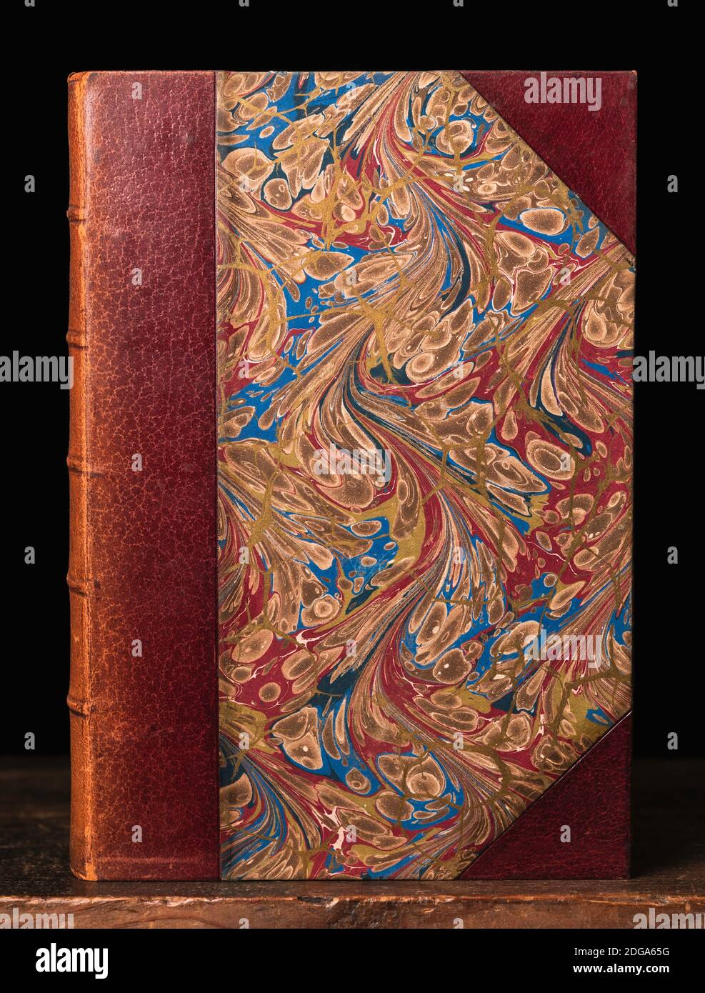 Leather bound antiquarian book with Florentine patterned paper Stock Photo