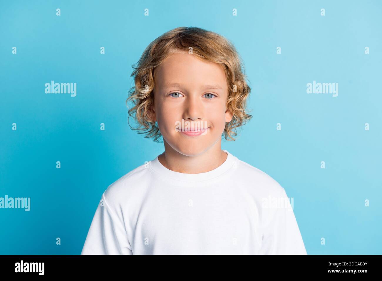 Portrait of pretty boy look in camera wear white tshirt isolated over