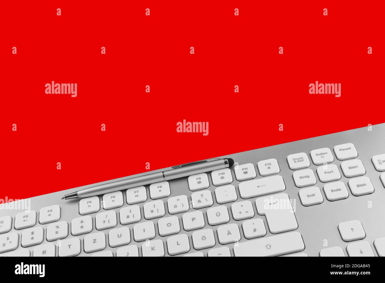 PC keyboard and pen against red background Stock Photo - Alamy