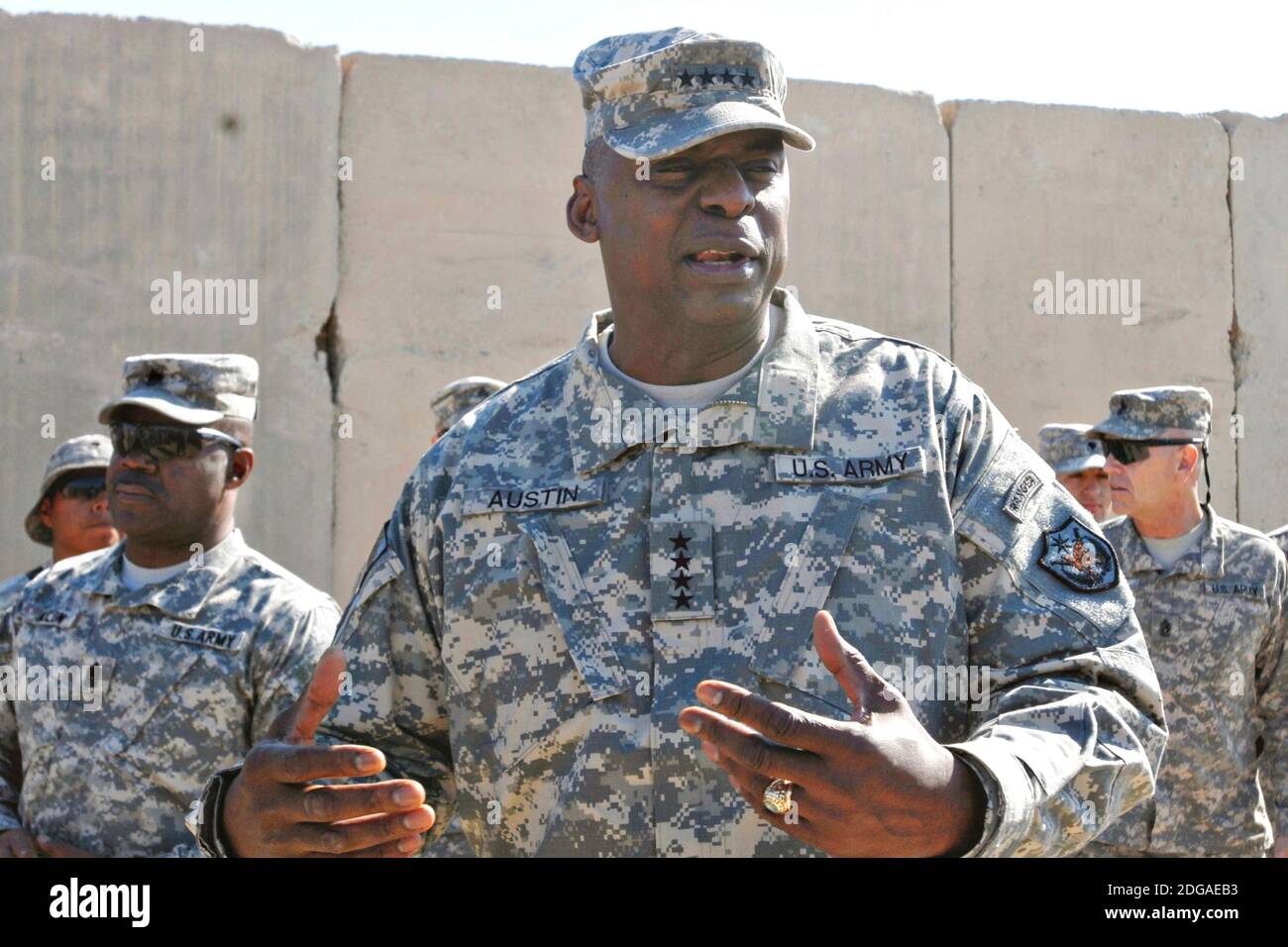 U.S. Army Lt. General Lloyd J. Austin III, right, commander of XVIII Airborne Corps, speaks to soldiers of the 4th Sustainment Brigade, 310th Expeditionary Sustainment Command at Contingency Operating Base Adder November 26, 2011 in Adder, Iraq. Stock Photo
