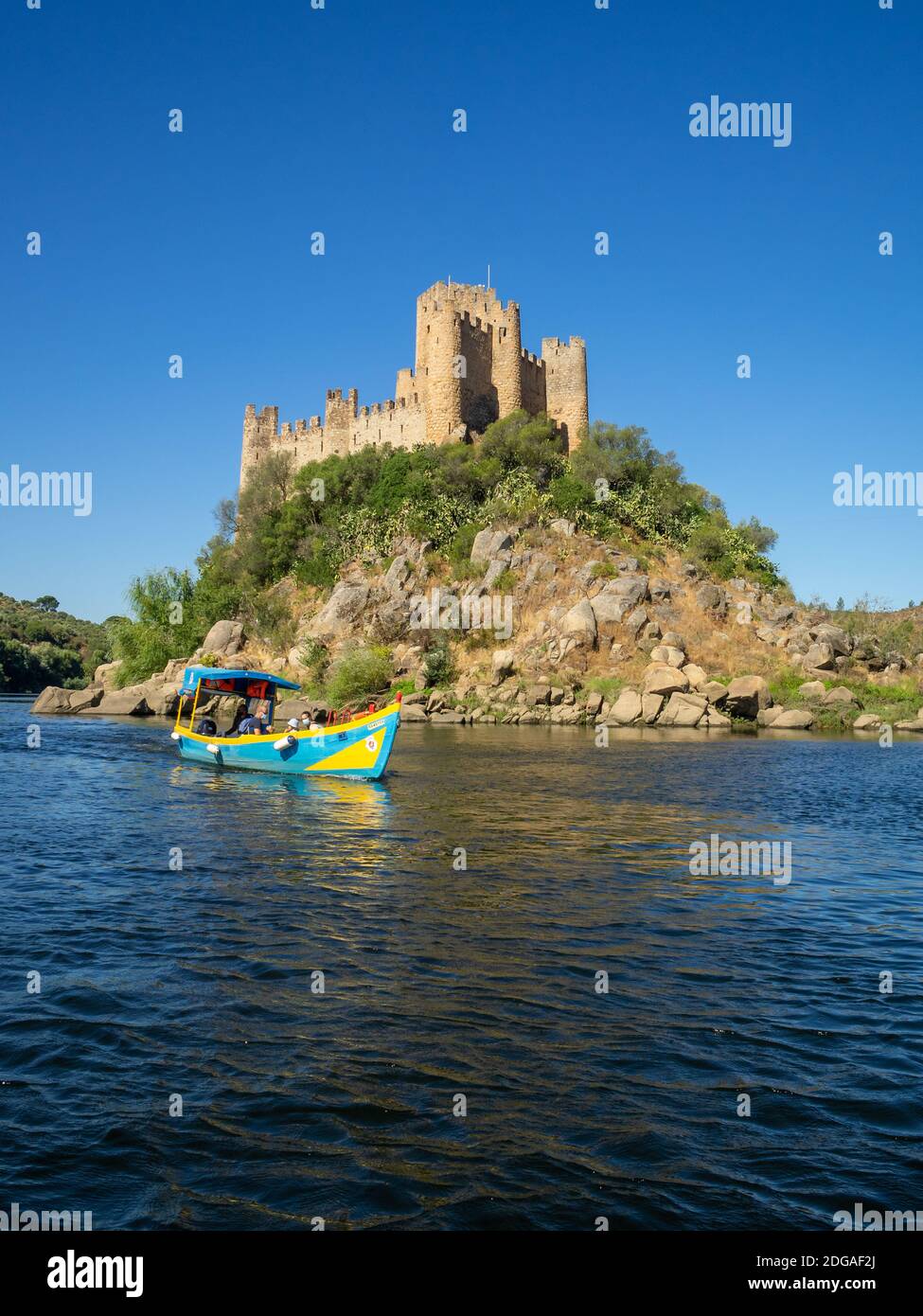 Tourist transportation boat by Almorol Castle in Tagus River Stock Photo