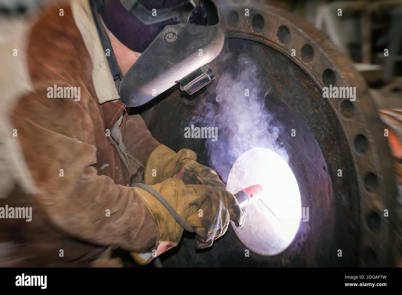 Welding works on metal  heat exchanger using manual arc welding Stock Photo