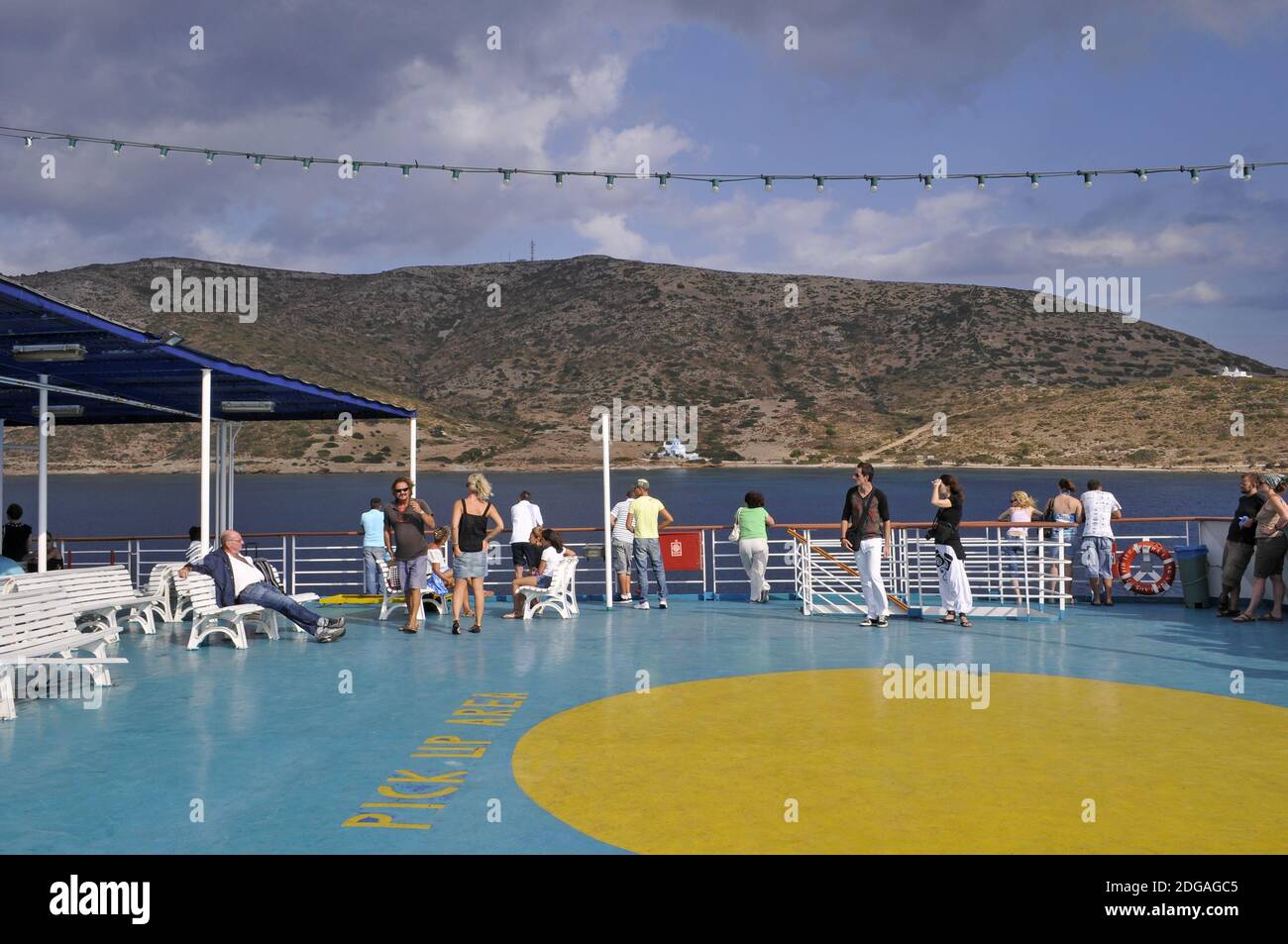 passengers and helipad area on the open deck of a ferry in front of Lipsi island, Dodecanese, Greece Stock Photo