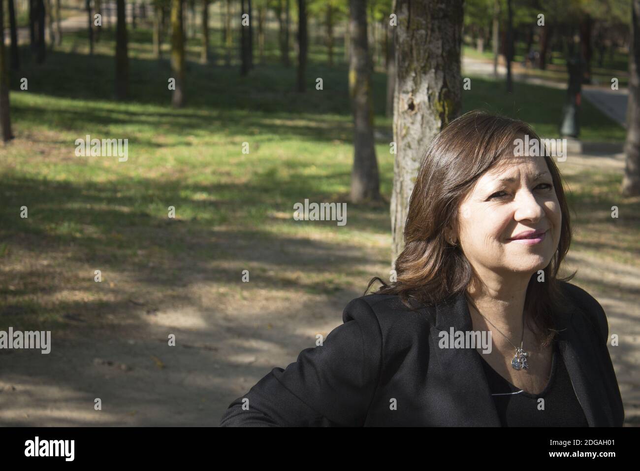 Mature woman in positive attitude sitting and standing Stock Photo - Alamy