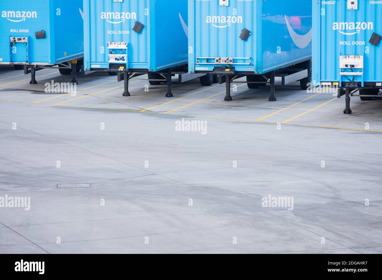08 December 2020, North Rhine-Westphalia, Mönchengladbach: Trucks bearing  the Amazon Prime logo stand in front of a logistics centre of the  mail-order company Amazon. A particularly large number of orders are  processed