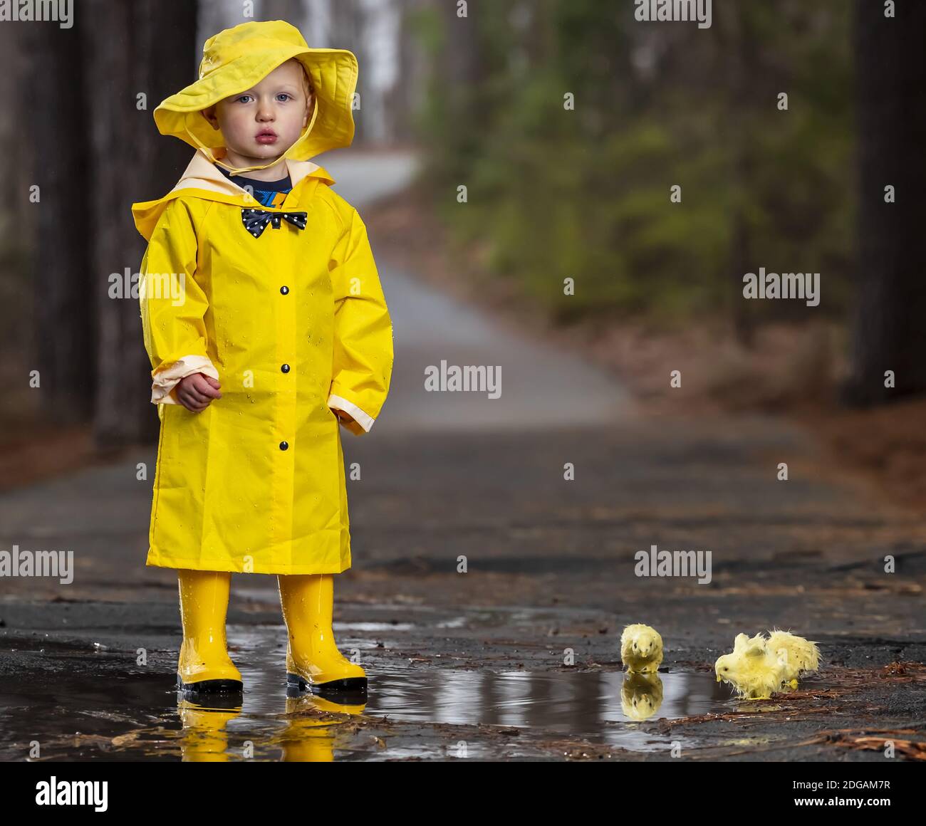 Child Enjoying The Rain In His Galoshes Stock Photo Alamy