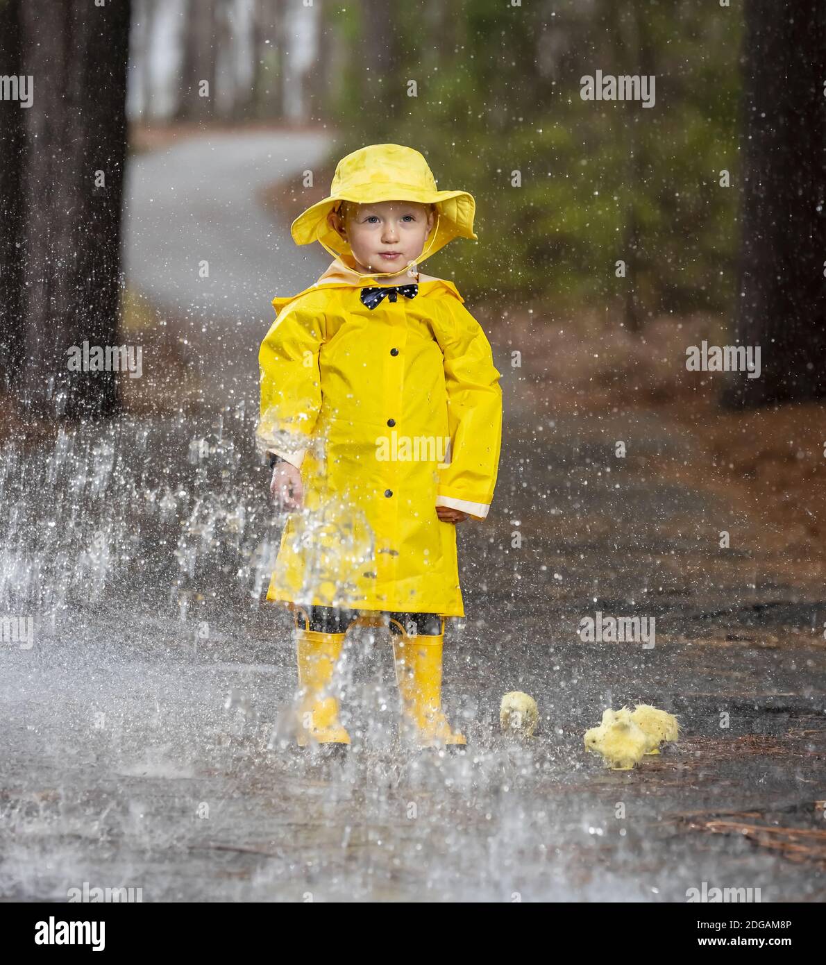 Child Enjoying The Rain In His Galoshes Stock Photo Alamy