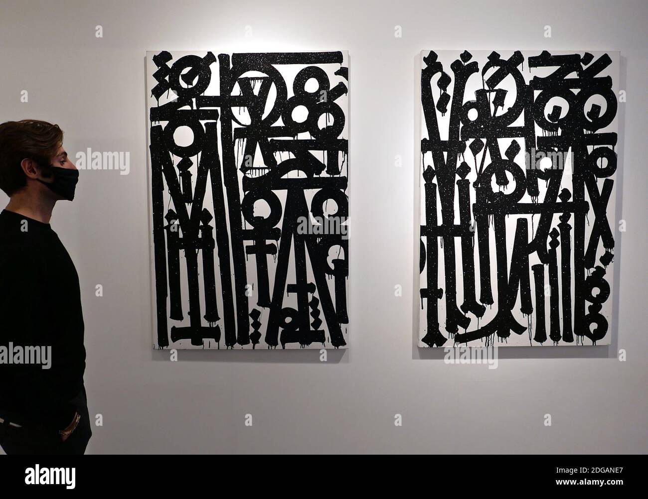 Retna ( Marquis Lewis ) the internationally nenowned street artist whose signature hieroglyphics are highly coveted by collectors on both sides of the Atlantic , unveiled new and never seen works in an exhibition titled Valle de Guadalipe on December 8 th 2020 at HOFA Gallery London . these soon to be released paintings vary in size , including three diptychs , and they showcase RETNA'S signature style infused with rejuvenated vigour , calligraphic flare and heightened precision arising from the artist's renewed creative clarity . Fiery red ,terracotta and brown and scripts written in gold . Stock Photo