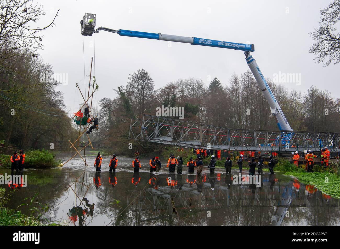 Denham, Buckinghamshire, UK. 8th December, 2020. In a huge HS2 and Police operation Police climbers were brought in today to pull eco warrior Dan Hooper known as Swampy out of a 30 feet high bamboo structure in the River Colne in Denham Country Park that he was locked onto. Activists were trying to stop HS2 putting a temporary bridge across the River Colne. Swampy was taken away by Police for questioning. Two protesters were dramatically pulled through the ice cold water by Police. Credit: Maureen McLean/Alamy Live News Stock Photo