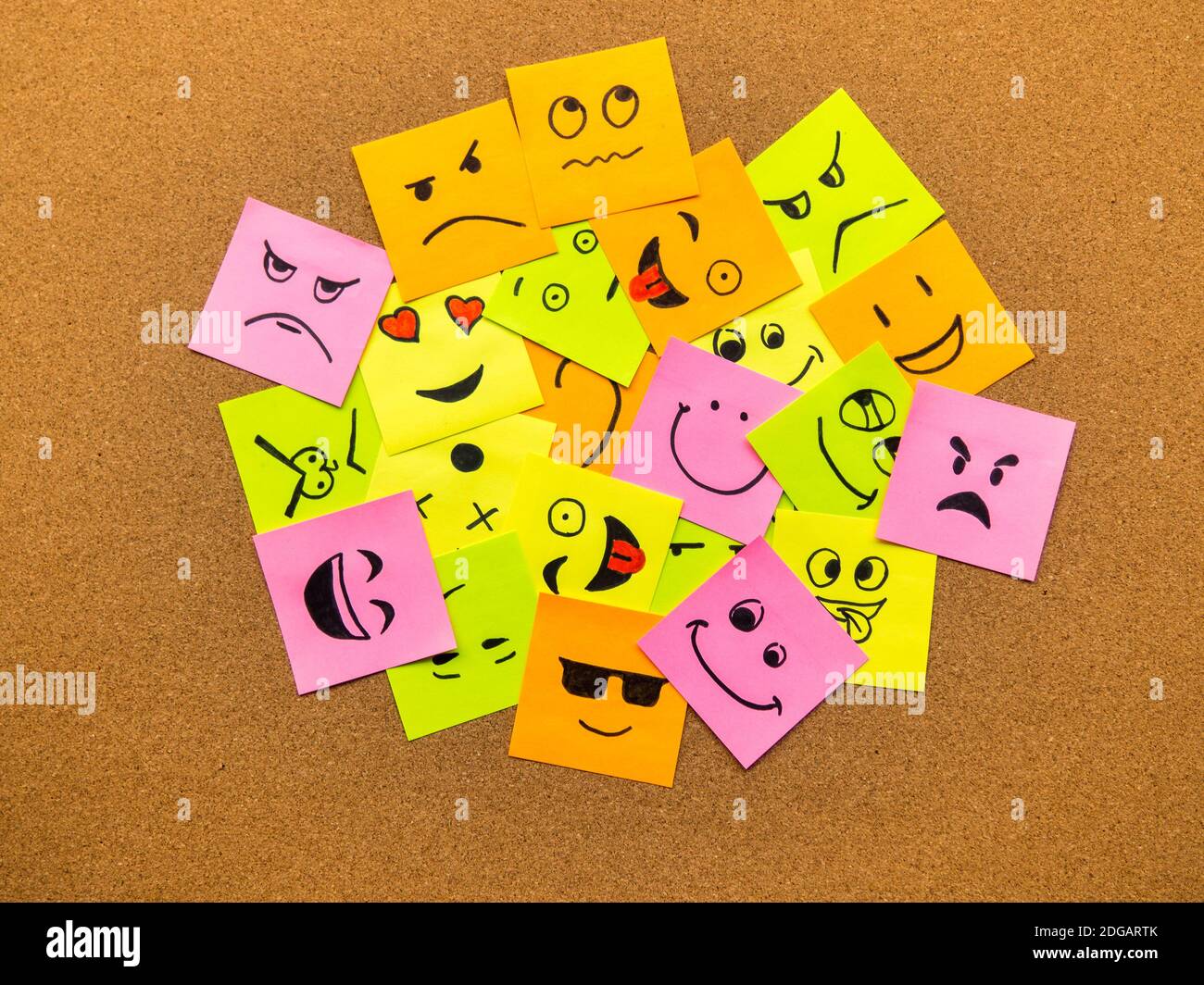 cork board with colorful post its representing various emoticons with various emotions communication concept Stock Photo