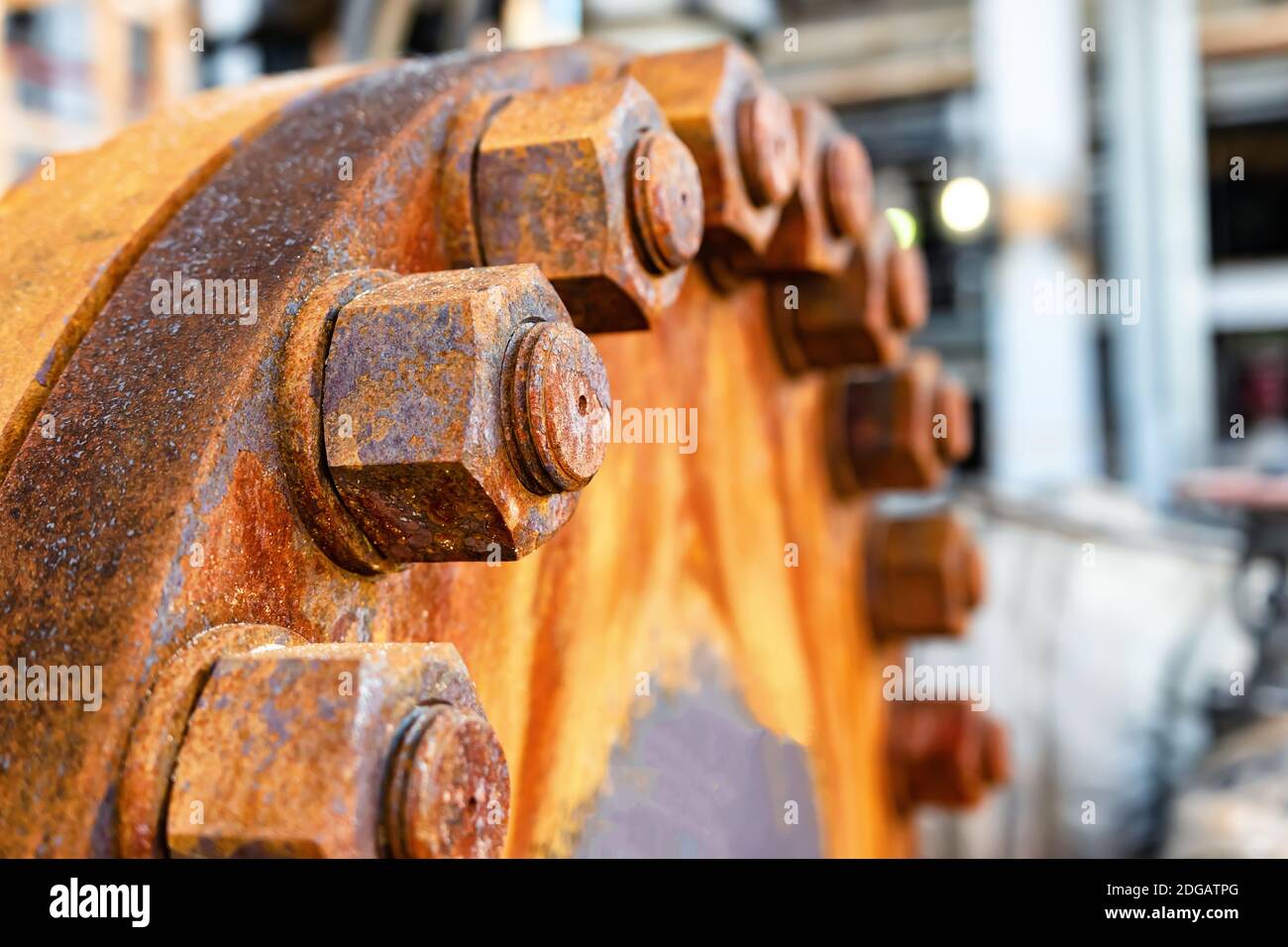 The cover of the old rusty heat exchanger covered with the same rusty bolts and nuts Stock Photo