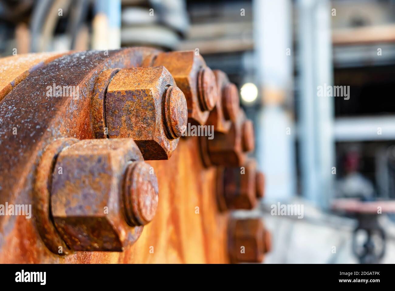 The cover of the old rusty heat exchanger covered with the same rusty bolts and nuts Stock Photo