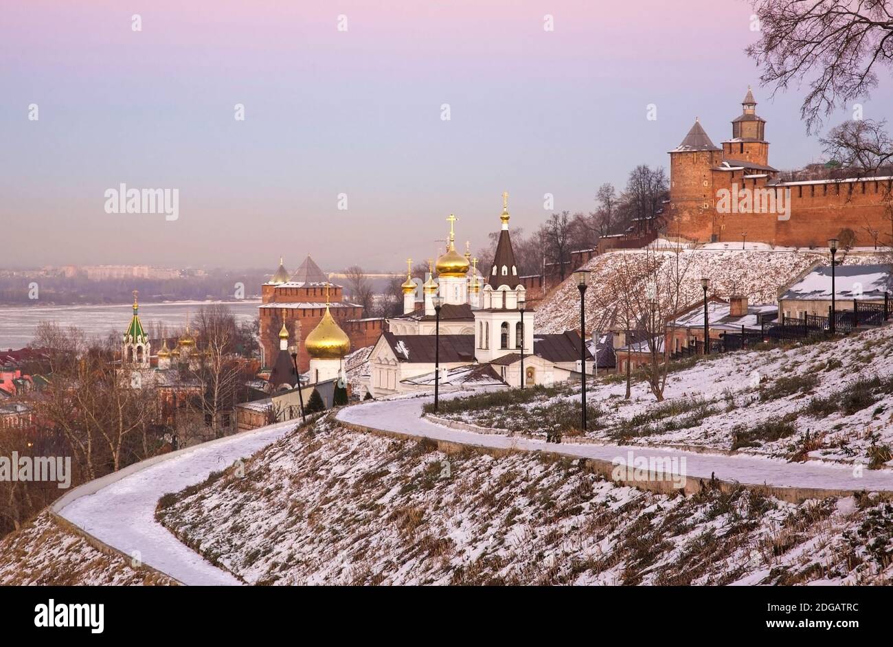 Orthodox Church and Nizhny Novgorod Kremlin in winter at pink sunset Stock Photo