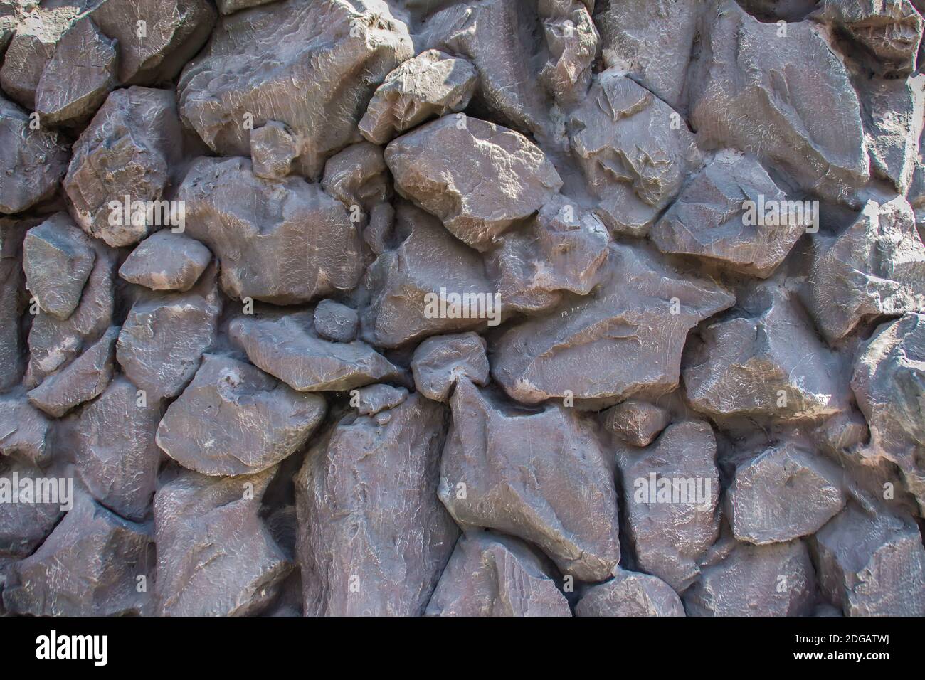 Painted black stone wall background. Black stone seamless pattern texture. Stock Photo