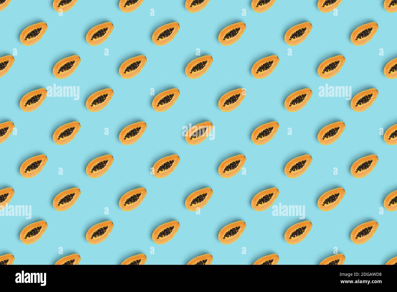 Summer pattern made with orange slice of papaya on bright  blue background. Minimal summer concept.Isometric view. Stock Photo