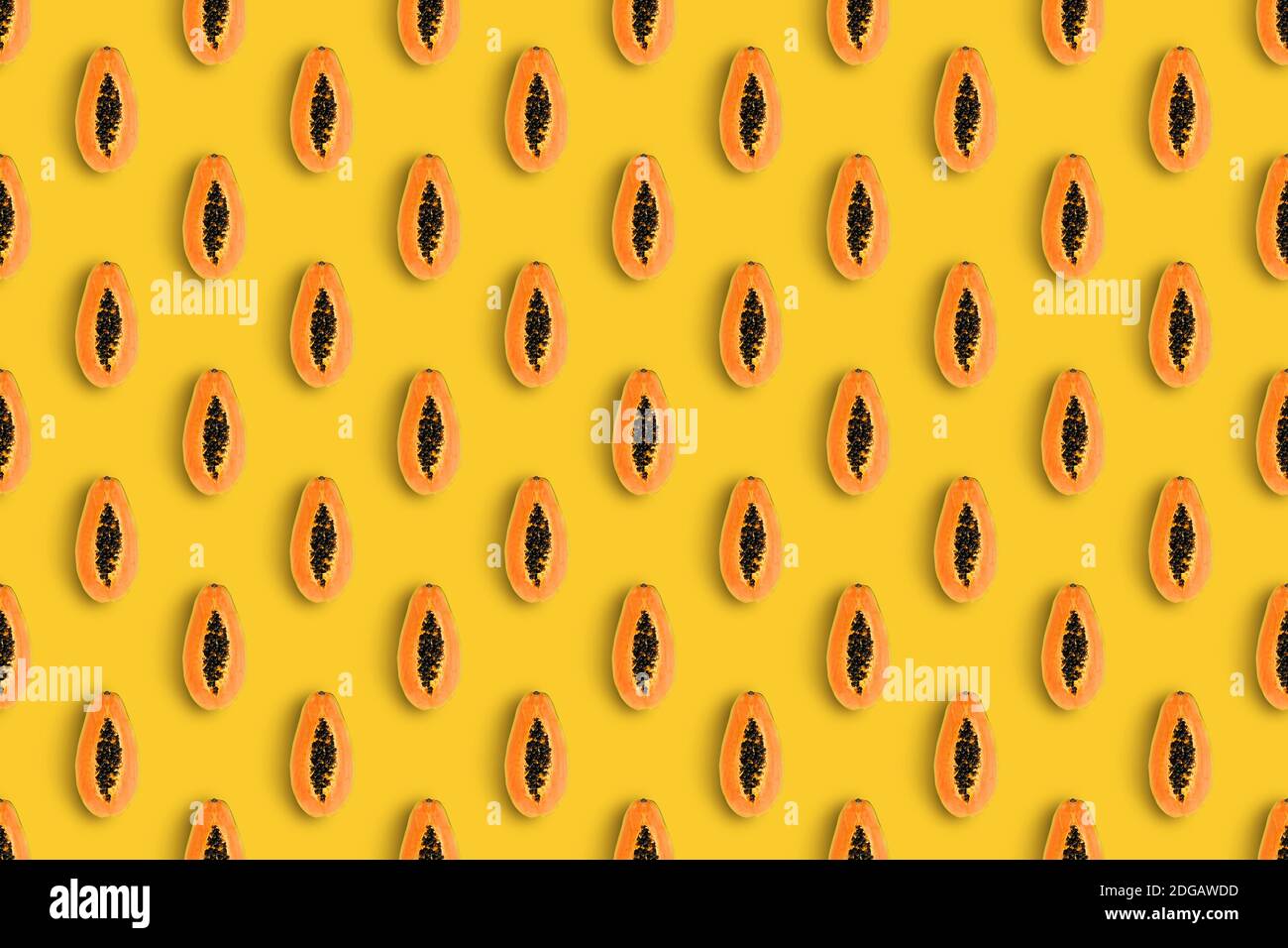 Summer pattern made with orange papaya on brightyellow background. Minimal summer concept. Isometric view. Stock Photo