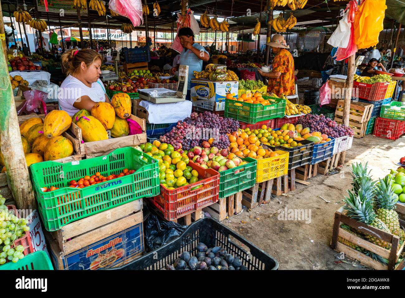 Peruvian people buy and sell fruits in the market at Nazca Peru Stock Photo