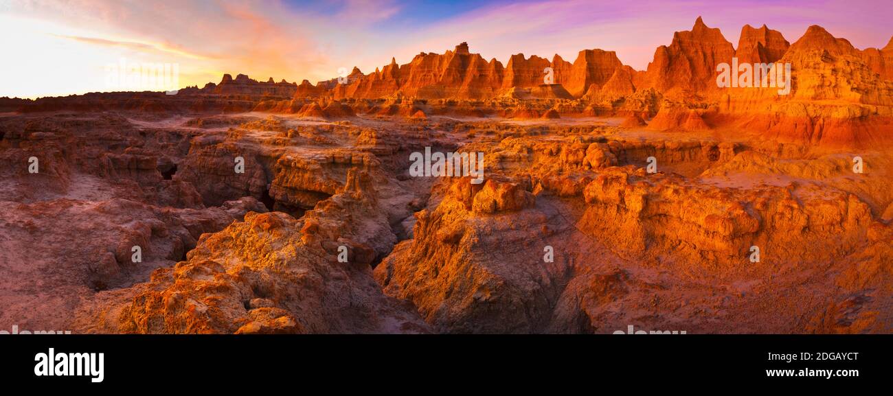 Alpenglow on rock formations at sunrise, Door Trail, Badlands National Park, South Dakota, USA Stock Photo