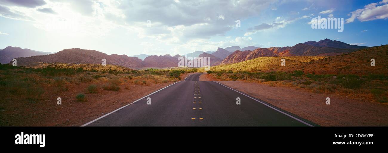 Road passing through a landscape with mountains in the background, Calico Basin, Red Rock Canyon National Conservation Area, Las Vegas, Nevada, USA Stock Photo