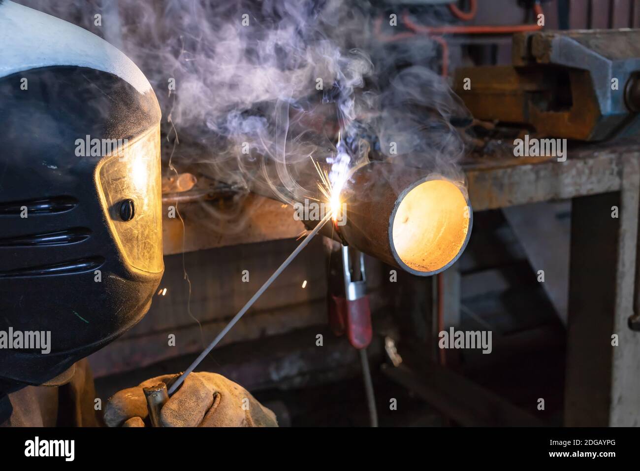Welder brews a control sample from small diameter pipes to confirm his qualification Stock Photo