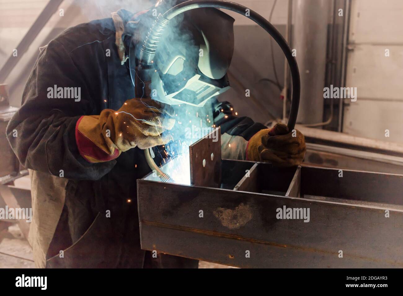 Welder performs welding work of metal structures Stock Photo