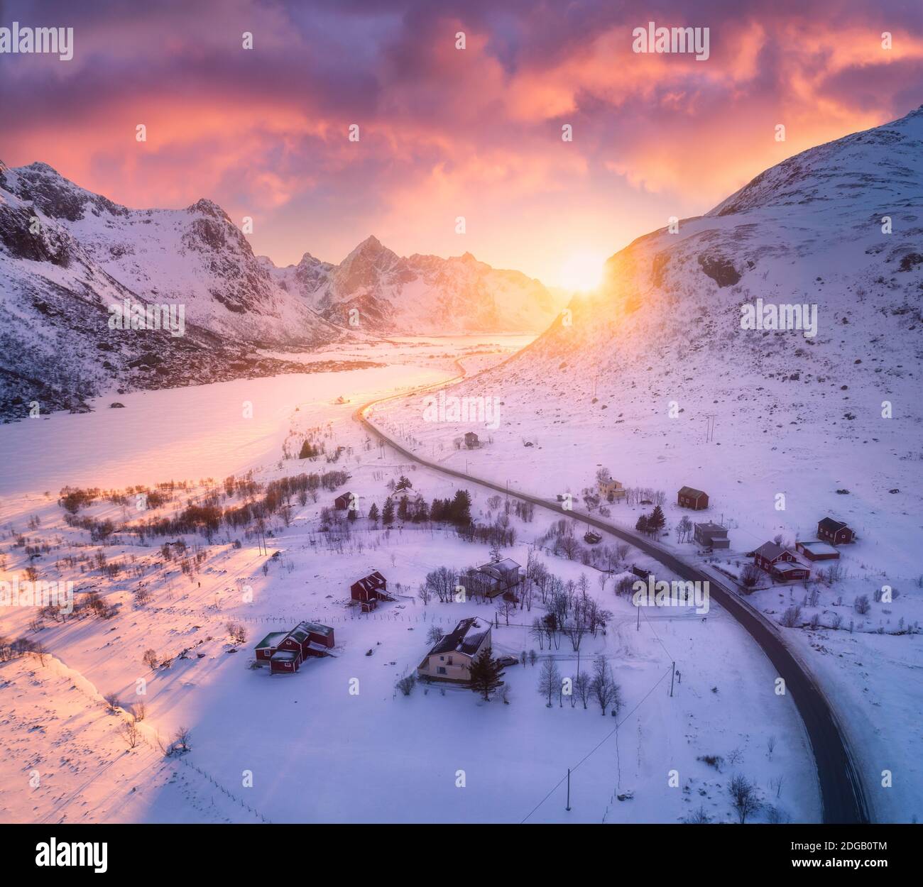 Beautiful road in snowy mountains in winter at sunset Stock Photo