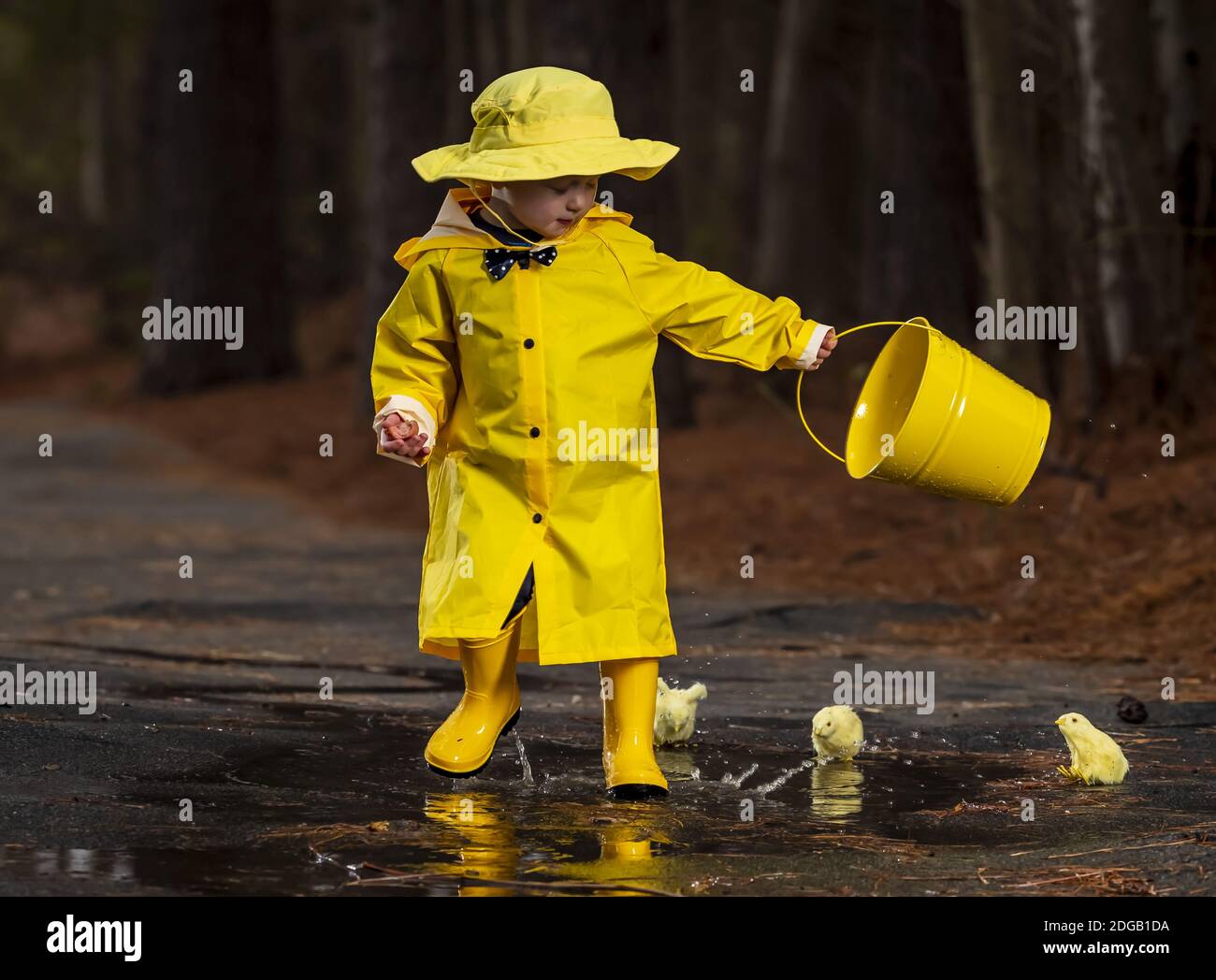 Child Enjoying The Rain In His Galoshes Stock Photo Alamy