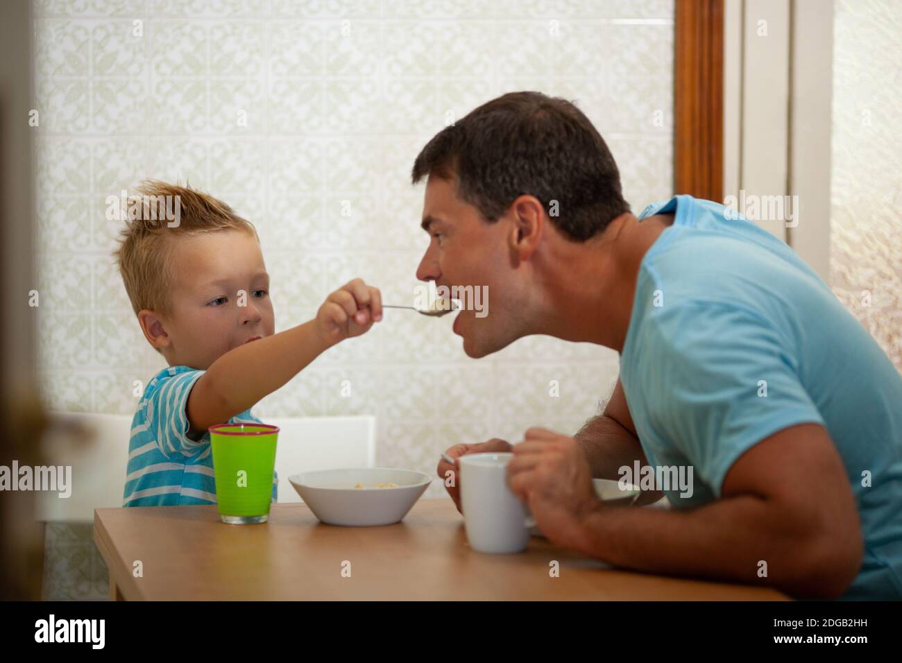 Spoonfeeding of a father Stock Photo Alamy