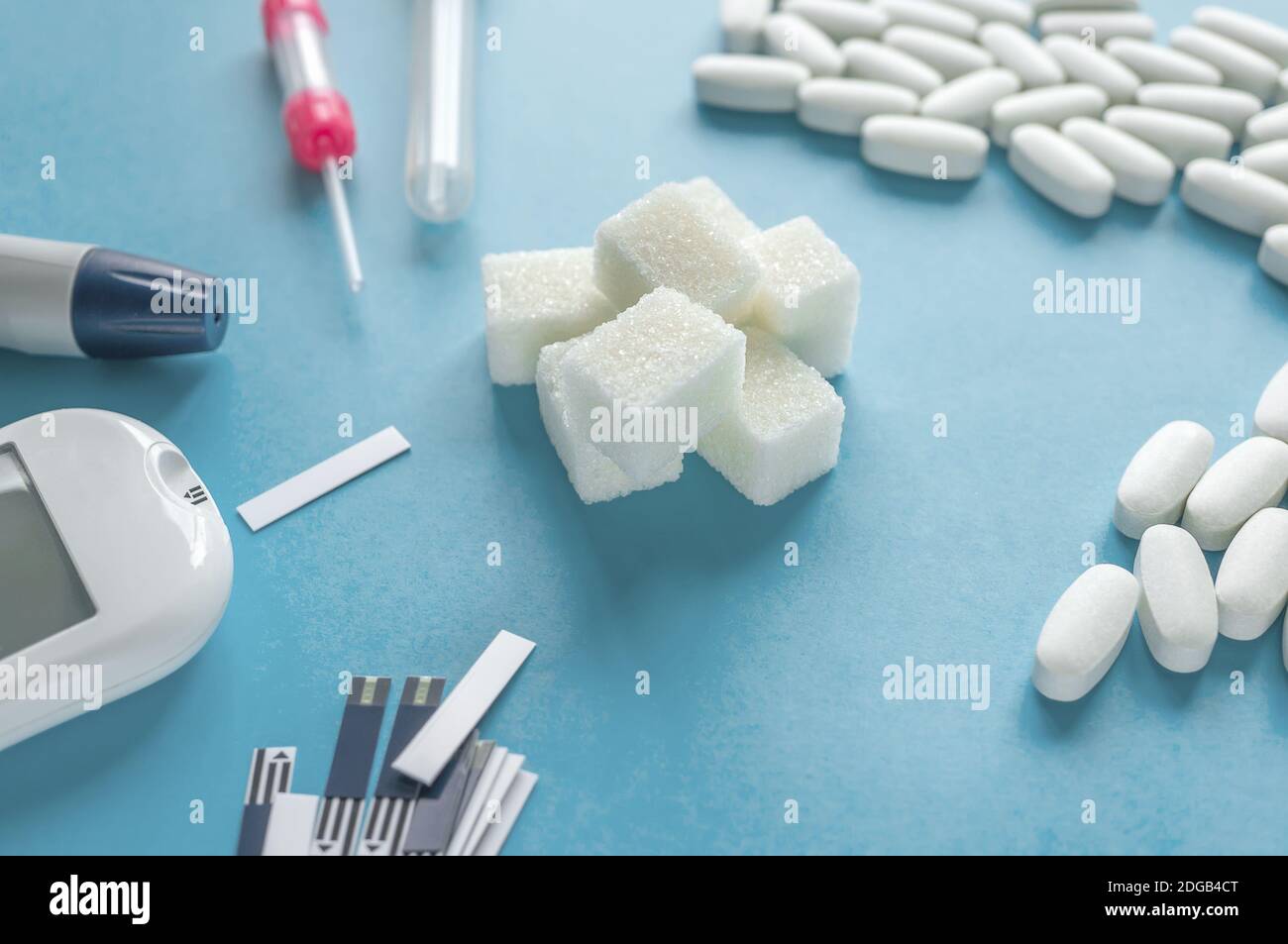 medicine, diabetes diagnostics, healthcare. concept. top view of a blood glucose meter and test strips checking blood sugar levels at home. Stock Photo