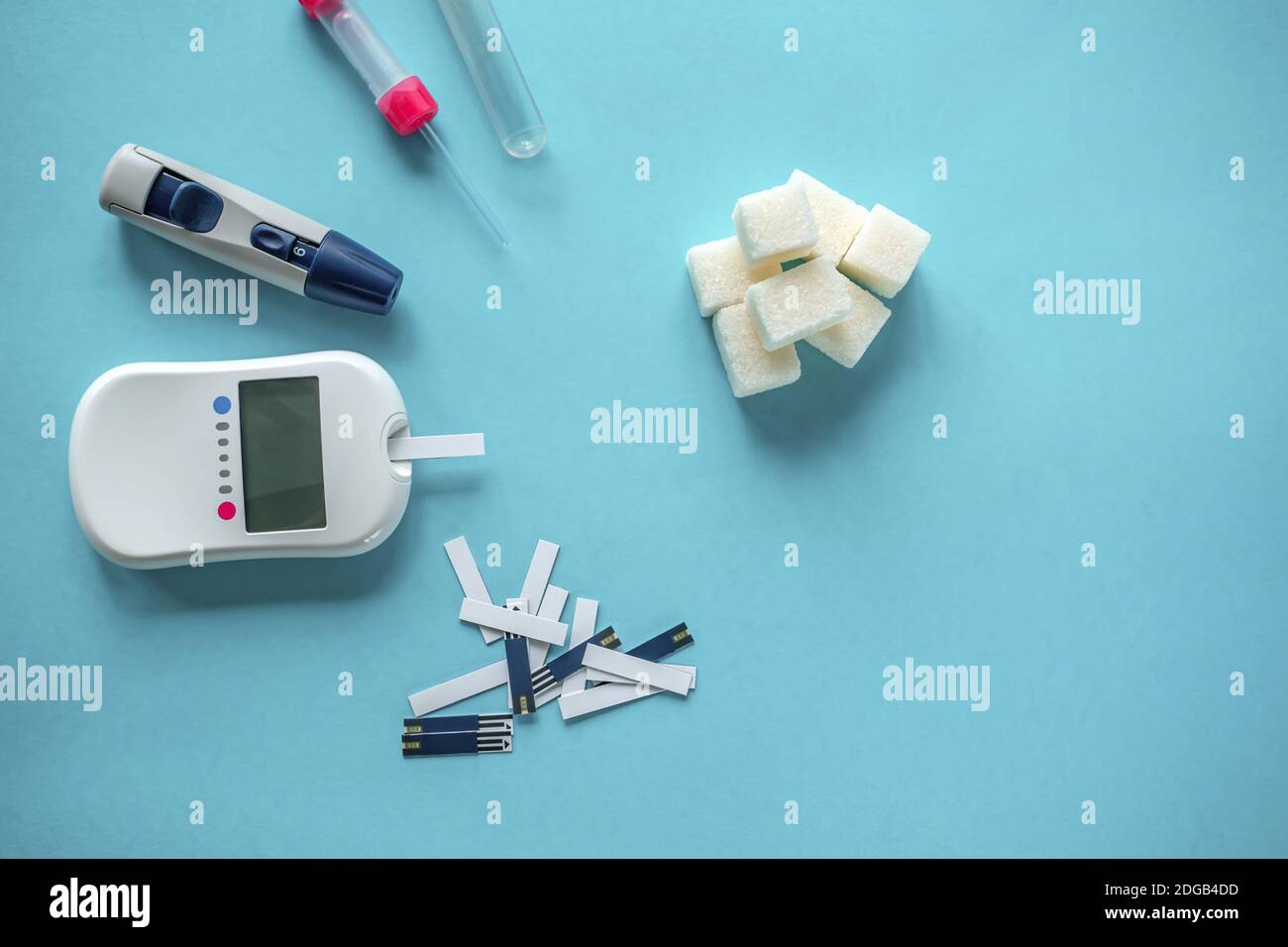 medicine, diabetes diagnostics, healthcare. concept. top view of a blood glucose meter and test strips checking blood sugar levels at home. Stock Photo
