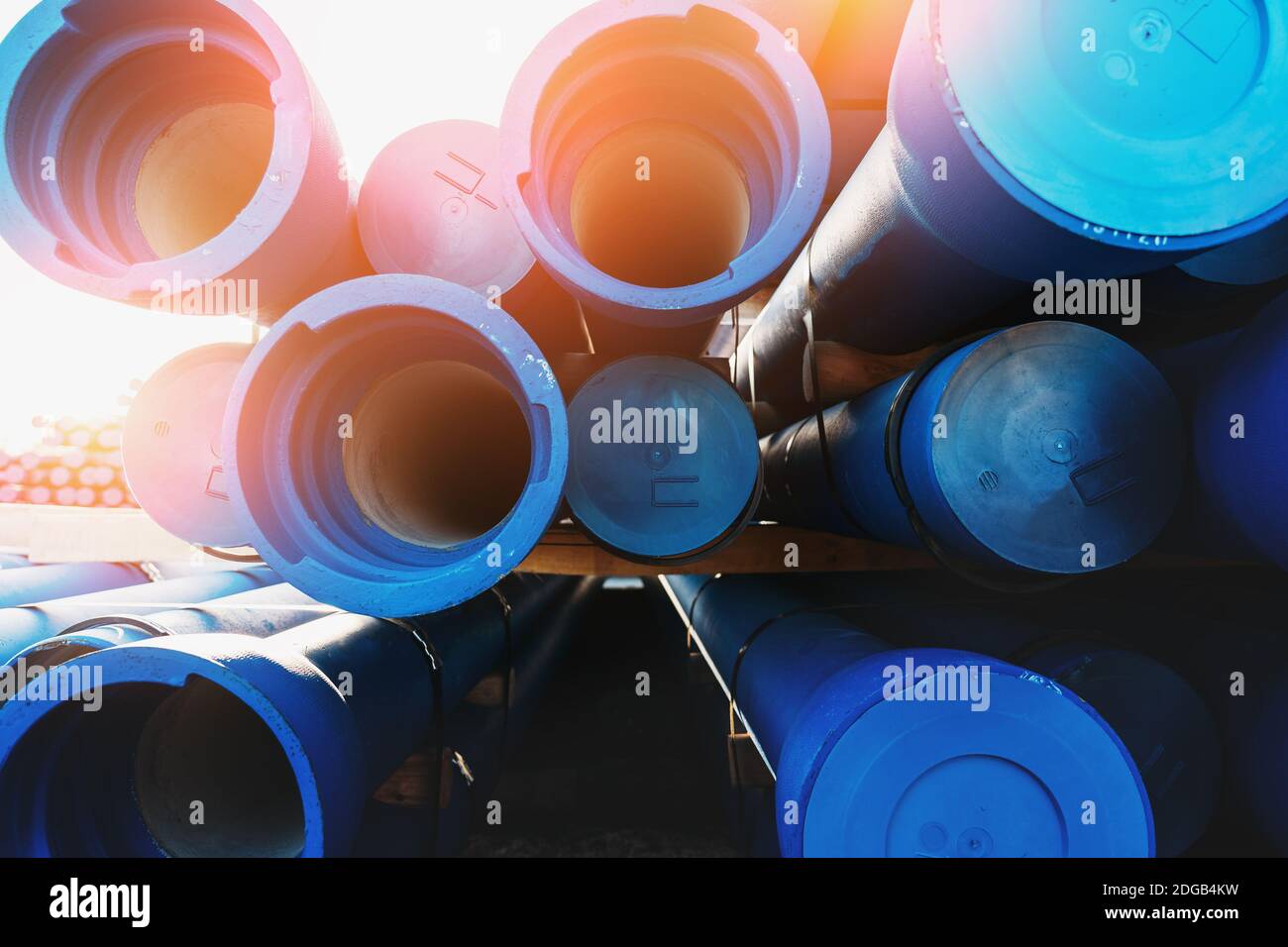 Big Blue Plastic PVC Water and Drain Pipes in sunlight. Stock Photo