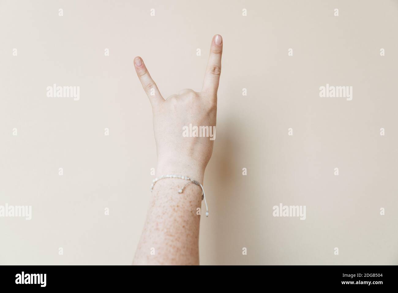 Woman's hand showing horns up gesture isolated Stock Photo Alamy