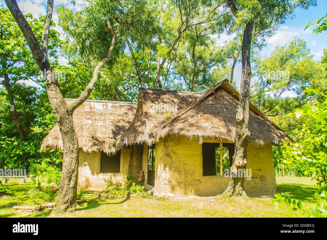 Earthen house under shade of trees. An earth house, also known as earth