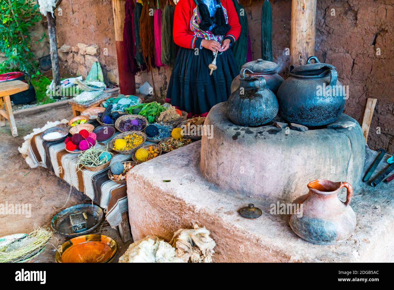 Inca woman and the simple equipment for natural dyeing wool process at Cusco Stock Photo