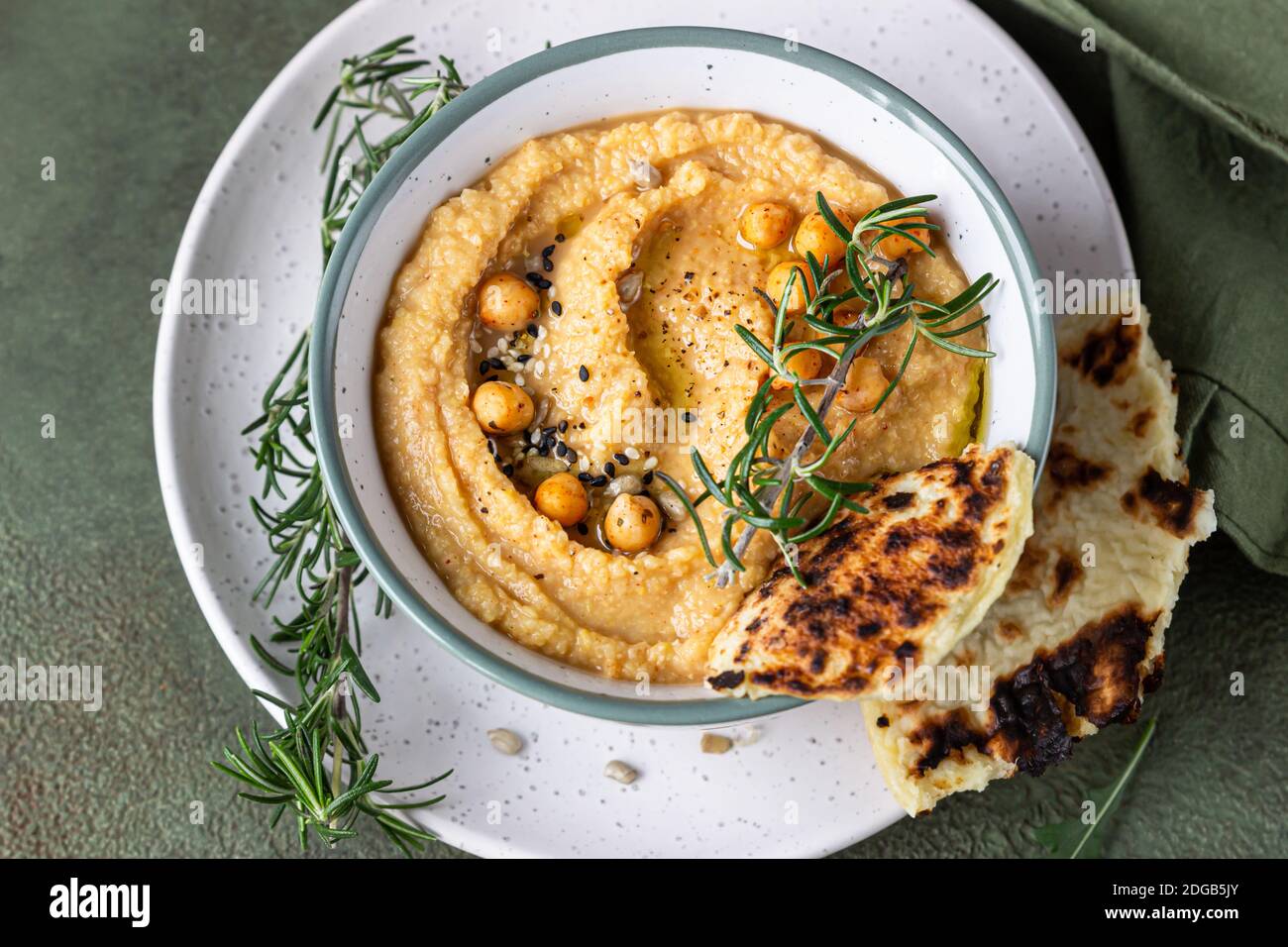 Classic hummus with rosemary, flatbread, boiled chickpea and olive oil