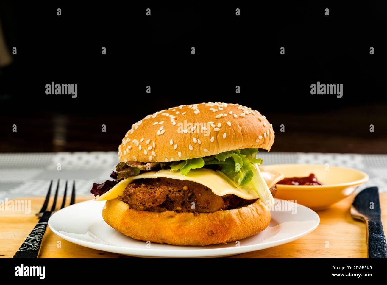Homemade chicken burger with cheese and vegetable in white plate Stock Photo