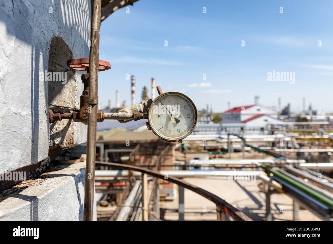 Properly working pressure gauge installed on the pipeline at the old chemical plant Stock Photo