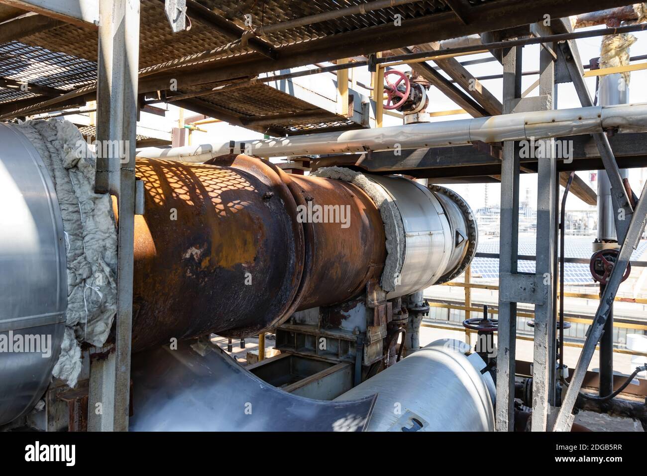 Replacement of thermal insulation on old rusty heat exchanger Stock Photo