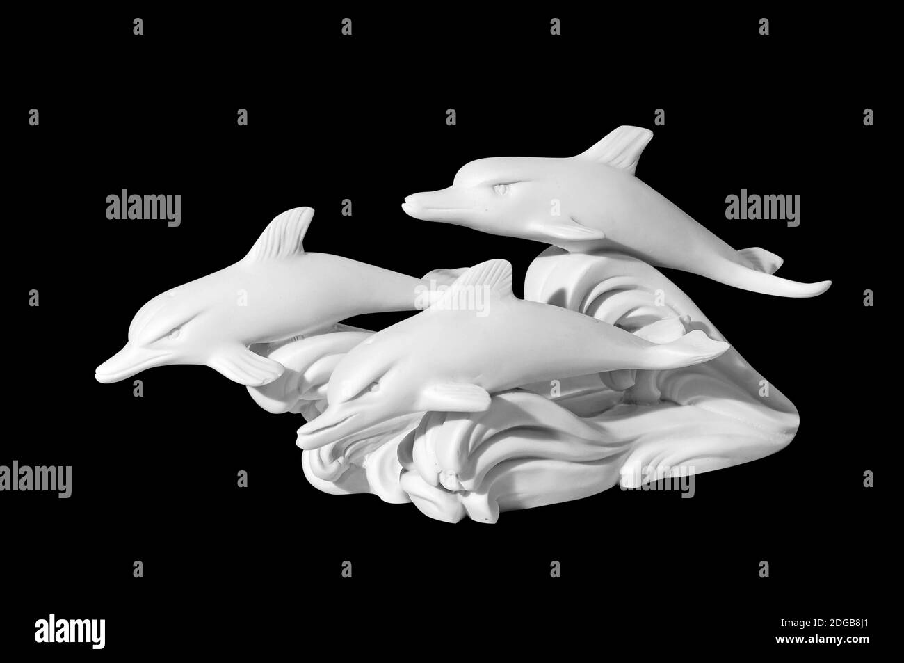 Statue of dolphins on a black background Stock Photo