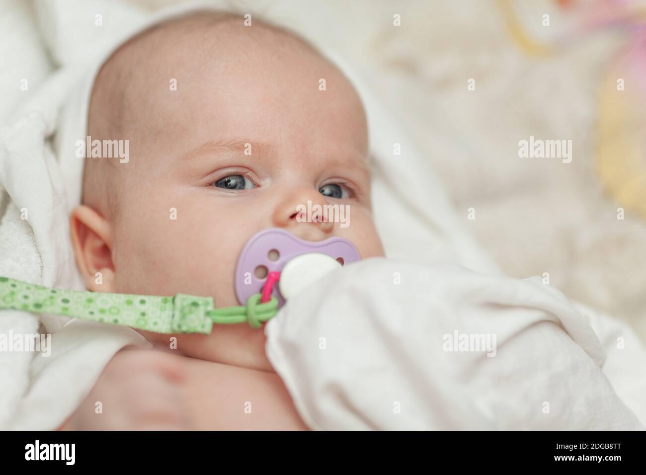 A portrait of a baby boy with a baby dummy Stock Photo