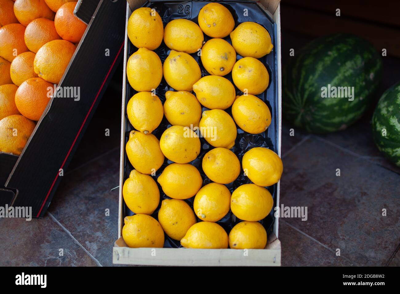 A closeup of bright lemons in a box Stock Photo