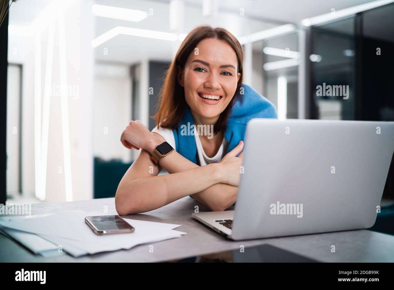 Portrait of happy successful caucasian woman in informal wear looking and smiling at the camera. Attractive female manager on self isolation after Stock Photo