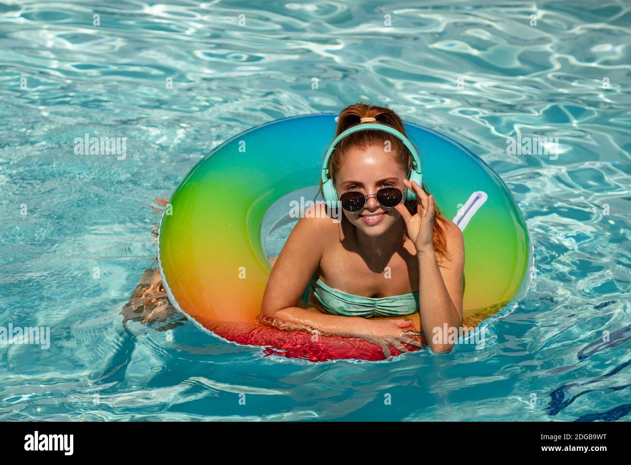 swimming pool. Cute funny teen relaxing ...